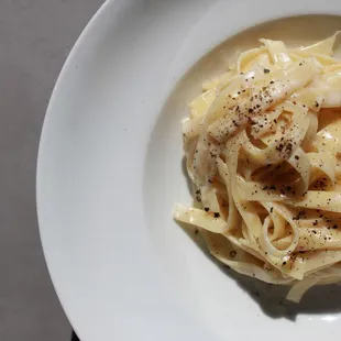 Fettuccine all&apos;Alfredo
 Homemade fettuccine in a creamed base butter and parmesan cheese sauce.