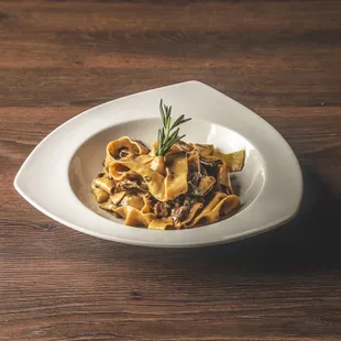 Homemade pappardelle in a cream sauce enriched with pieces from our dried porcini mushroom selection.