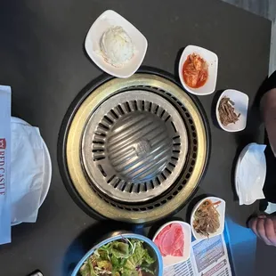 a woman sitting at a table with plates of food