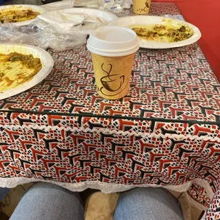 a person sitting at a table with plates of food