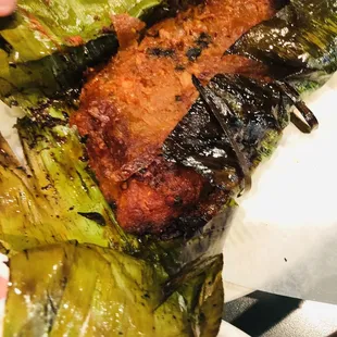 a plate of grilled meat on a bed of lettuce