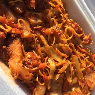 a container of noodles and meat