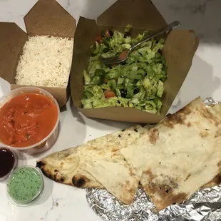 Butter chicken, naan, Garden Salad and mystery sauces but YUM! (One was mint.. the red was my fave)