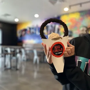 a woman holding a cup of ice cream