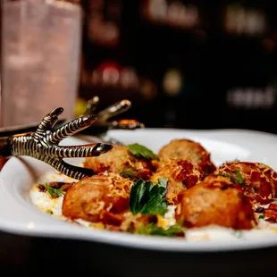 a plate of food with meatballs and sauce