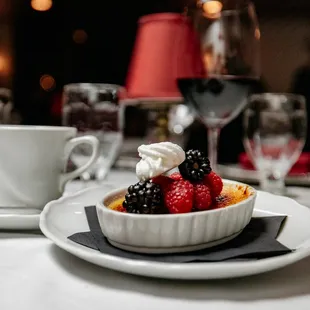 a dessert with berries and whipped cream