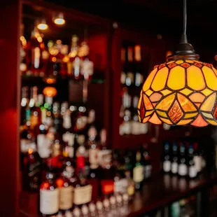 a bar filled with bottles of alcohol