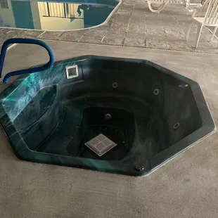 Empty hot tub, closed pool.