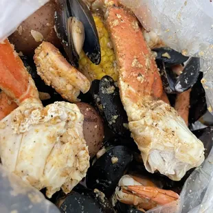 crab legs, mussels, potatoes, and corn