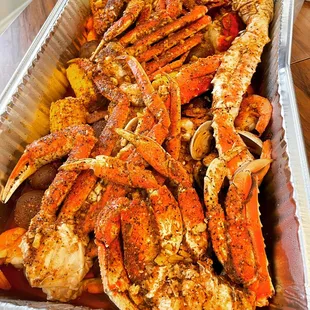 Snow crab, lobster, Dungeness crab, king crab, clams, shrimp, potatoes, corn, sausage