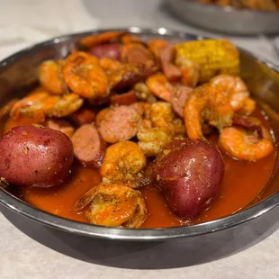 a bowl of shrimp, shrimp, and potatoes