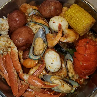 Seafood boil w/snow crablegs,  green mussels,  lobster tail, jumbo shrimp,  corn, potatoes and eggs