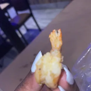 a hand holding a piece of food