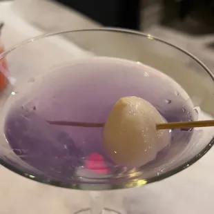 a close up of a purple cocktail