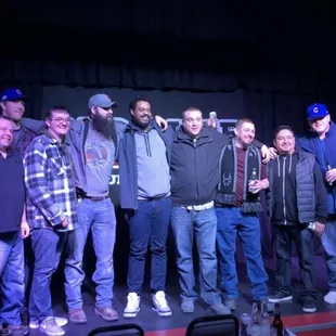 a group of men standing on a stage