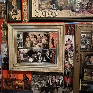 a wall full of photos and posters