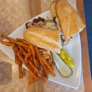 Hot pastrami sandwich with sweet potato fries.