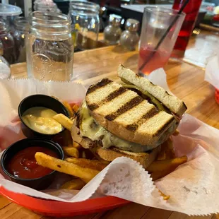 a grilled sandwich and fries