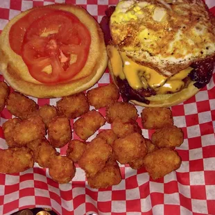 1/2 pound burger with bacon, mushrooms, cheese, tomato and fried egg with tots. Half price build your own burger day