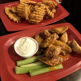 Spicy garlic chicken wings with blue cheese and waffle fries