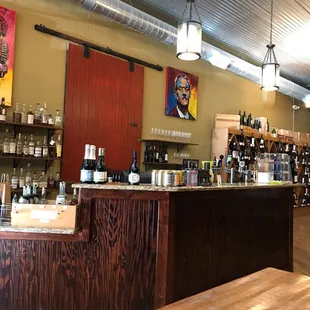 a wooden counter with bottles of wine