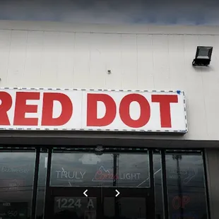 a red dot sign on a building