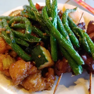 a plate of green beans and meat