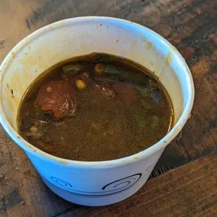 shows a cup of soup on a table