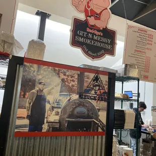 shows a man standing in front of the sign