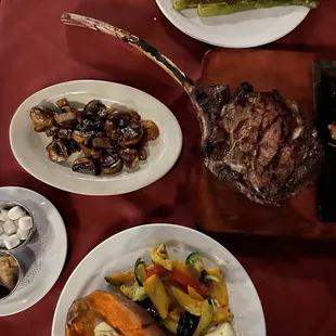 The Tomahawk steak for 2. Grilled vegetables, sweet potato, grilled asparagus and green beans. Added sautéed mushrooms and onions.