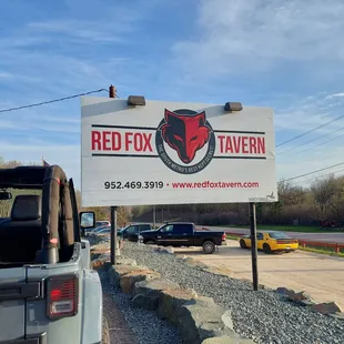 a car parked in front of a sign