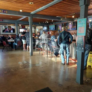 people sitting at tables in a restaurant