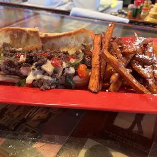 Philly cheese steak with sweet potato fries.