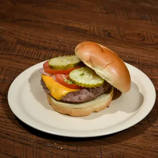 a hamburger with pickles and tomatoes