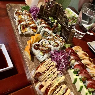 a variety of sushi on a wooden platter