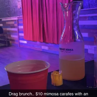 a pitcher and a cup of liquid