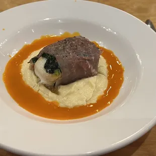 Halibut with wilted spinach, wrapped in prosciutto and served on creamed/mashed parsnips and a carrot juice and seatings/herbs reduction.