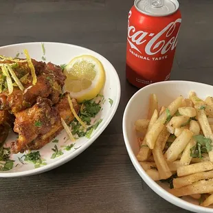 two bowls of fries and a can of coke