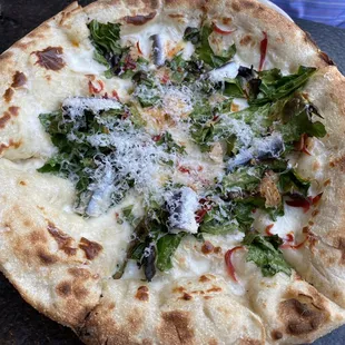 a pizza with spinach and cheese