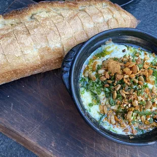 a bowl of food and a loaf of bread