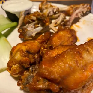 a plate of chicken wings and celery