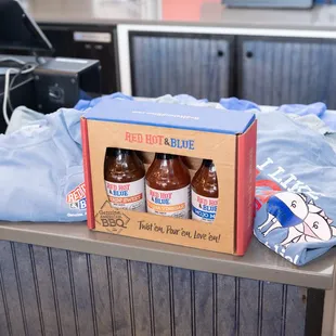 three bottles of hot sauce in a box