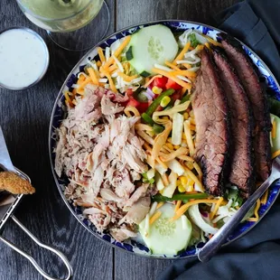 Smokehouse Salad. Fort Worth Turkey and Texas Brisket over seasonal greens and fixins.