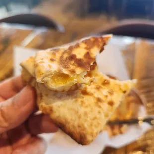 a hand holding a piece of food
