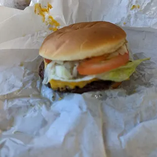 a hamburger with lettuce, tomato, and cheese