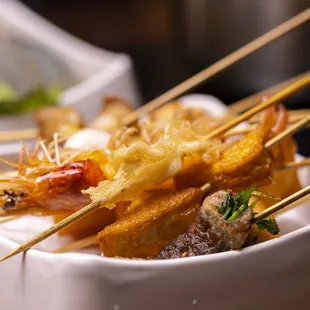 skewered food in a white bowl