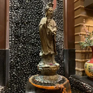 a fountain with a statue in the center