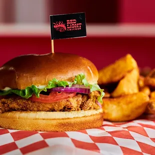 a fried chicken sandwich with lettuce and tomato