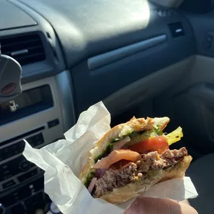 a hand holding a sandwich