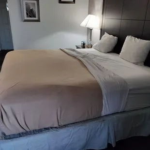 The bed is made with the sheet and blanket almost  halfway down the bed and there were just these dinky pillows.